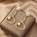 Earrings Veile Studios Gold Round Pearl With Crystal Accents And Snake Design For Women